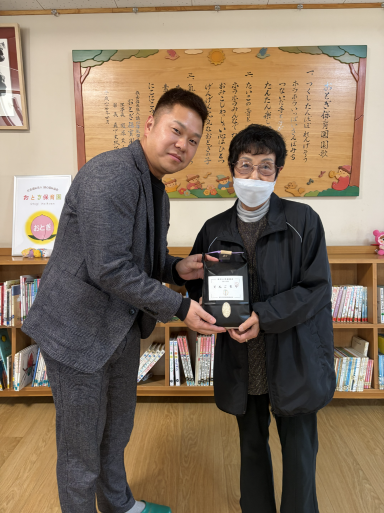 おとぎ保育園の園長先生へお米を寄付しているところ